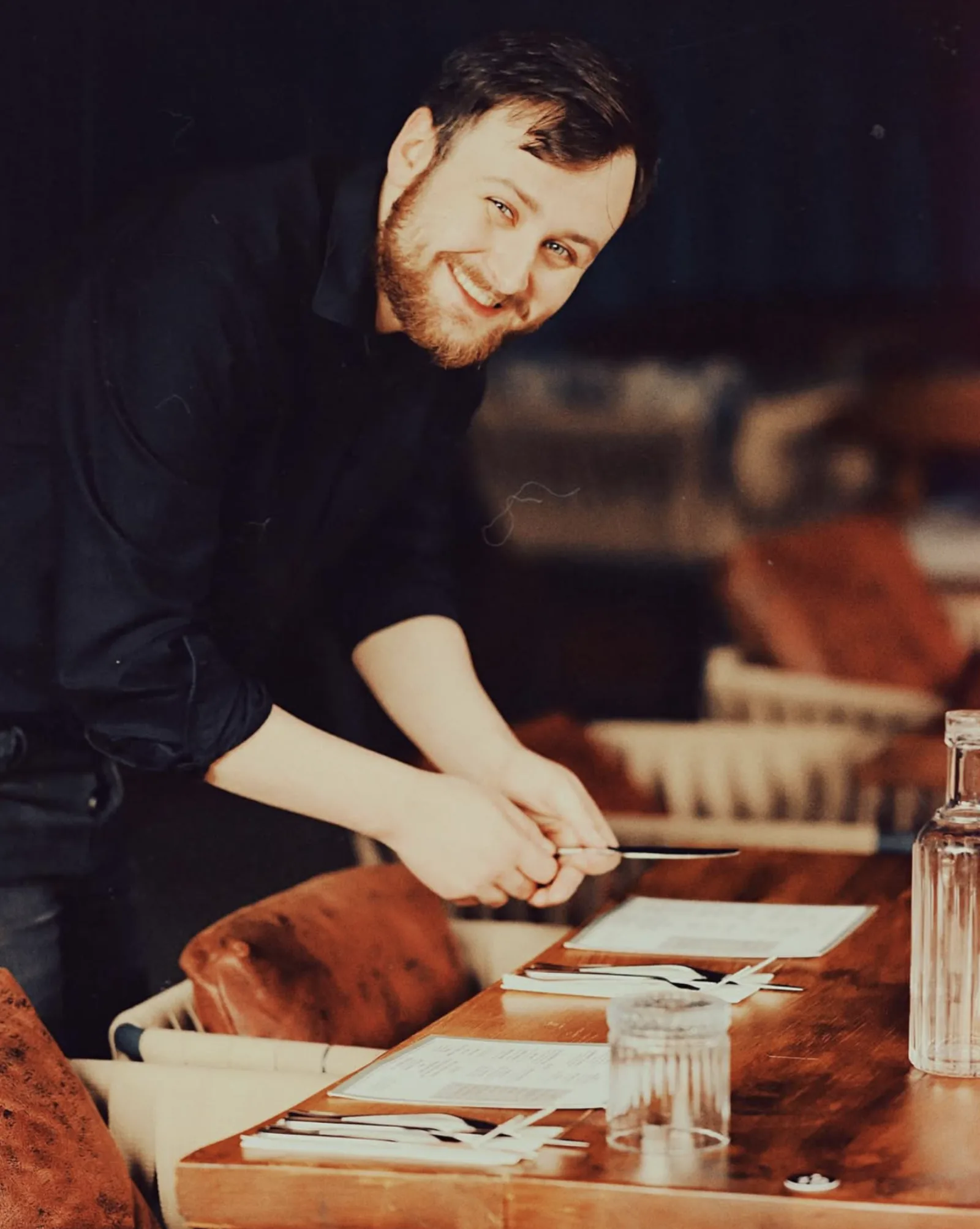 A team member setting a table for service
